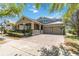 Inviting single-story home with brick driveway, well-kept lawn, and a convenient two-car garage at 6799 Helmsley Cir, Windermere, FL 34786