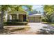 Charming home featuring a two-car garage, front porch, and landscaped yard at 6799 Helmsley Cir, Windermere, FL 34786
