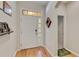 Bright foyer with wood floors and a modern white door with glass panes, offering a welcoming entrance at 6799 Helmsley Cir, Windermere, FL 34786