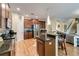 Open kitchen with modern appliances, granite counters, and dark wood cabinets at 6799 Helmsley Cir, Windermere, FL 34786