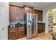 Kitchen featuring stainless steel refrigerator and mosaic tile backsplash at 6799 Helmsley Cir, Windermere, FL 34786
