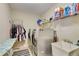 Bright laundry room including full sized washing machine, dryer, and sink at 6799 Helmsley Cir, Windermere, FL 34786