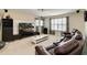 Comfortable living room with plush leather seating, entertainment center, and plenty of natural light at 6799 Helmsley Cir, Windermere, FL 34786