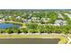 Scenic view featuring a paved walking path alongside a tranquil pond, framed by lush trees and greenery at 6799 Helmsley Cir, Windermere, FL 34786