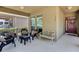 Cozy front porch featuring outdoor seating, a bench, and an inviting entrance with a red door at 6799 Helmsley Cir, Windermere, FL 34786