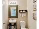 Small powder room featuring a decorative mirror at 6799 Helmsley Cir, Windermere, FL 34786