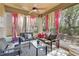 Relaxing sunroom with comfortable seating, a ceiling fan and natural light at 6799 Helmsley Cir, Windermere, FL 34786