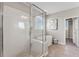 This bathroom boasts a glass shower, soaking tub, neutral walls, and light tile flooring at 7131 Desert Mandarin St, Winter Garden, FL 34787
