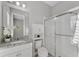 A well-lit bathroom with white cabinets, granite countertops, and a stand-up shower at 7131 Desert Mandarin St, Winter Garden, FL 34787