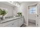 A bright bathroom with granite countertops, double sinks, and tiled floor at 7131 Desert Mandarin St, Winter Garden, FL 34787