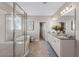 Bright bathroom features a soaking tub and separate shower, a large vanity and a walk-in closet at 7131 Desert Mandarin St, Winter Garden, FL 34787