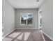A carpeted bedroom with neutral walls and natural light from a window at 7131 Desert Mandarin St, Winter Garden, FL 34787