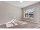 A simple carpeted bedroom with neutral walls and natural light from a window at 7131 Desert Mandarin St, Winter Garden, FL 34787