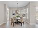 Bright dining area features a round table, four chairs, tile floors, and a modern pendant light fixture at 7131 Desert Mandarin St, Winter Garden, FL 34787