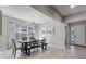 Bright dining room featuring tile floors, modern light fixture, and a contemporary dining table with bench seating at 7131 Desert Mandarin St, Winter Garden, FL 34787