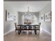 Bright dining room featuring tile floors, modern light fixture, and a contemporary dining table with bench seating at 7131 Desert Mandarin St, Winter Garden, FL 34787