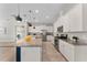 Open kitchen features stainless appliances, white cabinets, granite countertops, a large island, and tile floors at 7131 Desert Mandarin St, Winter Garden, FL 34787