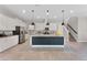 Modern kitchen featuring white cabinets, a granite island with pendant lighting, stainless steel appliances, and tile floors at 7131 Desert Mandarin St, Winter Garden, FL 34787
