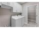 Convenient laundry room features a modern washer and dryer with storage cabinets at 7131 Desert Mandarin St, Winter Garden, FL 34787