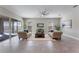 Sun-filled living room features a modern ceiling fan, neutral decor, tile floors, and sliding doors at 7131 Desert Mandarin St, Winter Garden, FL 34787