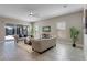 Bright living room with tile floors, a ceiling fan, comfortable couches, and sliding glass doors to the patio at 7131 Desert Mandarin St, Winter Garden, FL 34787