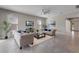 Bright living room features a ceiling fan, neutral walls, tile floors, and modern furniture at 7131 Desert Mandarin St, Winter Garden, FL 34787