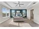 Carpeted main bedroom features a tray ceiling, accent wall, and two windows with blinds at 7131 Desert Mandarin St, Winter Garden, FL 34787