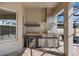 Built-in outdoor kitchen with granite countertops, stainless steel appliances, and storage on the screened-in patio at 7131 Desert Mandarin St, Winter Garden, FL 34787