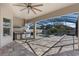 Covered patio area featuring a complete outdoor kitchen, ceiling fan, and a view of the screened-in pool at 7131 Desert Mandarin St, Winter Garden, FL 34787