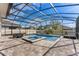 Screened-in pool and spa area with brick pavers and outdoor seating, perfect for entertaining at 7131 Desert Mandarin St, Winter Garden, FL 34787