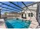 View of the screened-in pool and spa area with comfortable outdoor seating at 7131 Desert Mandarin St, Winter Garden, FL 34787