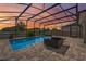 Spacious screened-in pool and spa, offering a tranquil outdoor experience with lovely evening colors at 7131 Desert Mandarin St, Winter Garden, FL 34787