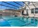 Backyard pool and spa, fully screened-in, with outdoor seating and patio at 7131 Desert Mandarin St, Winter Garden, FL 34787