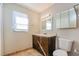 Well-lit bathroom featuring a vanity with storage and a framed mirror at 7355 Rush Ct, Orlando, FL 32818