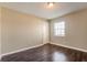 Cozy bedroom featuring wood-look flooring and natural light at 7355 Rush Ct, Orlando, FL 32818