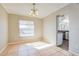 Dining room with tile floors, chandelier, and window, adjacent to the kitchen at 7355 Rush Ct, Orlando, FL 32818
