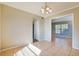 Dining room with tile floors and an open archway looking into the living room at 7355 Rush Ct, Orlando, FL 32818