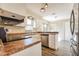 Updated kitchen with modern appliances, countertops, and a view into the dining area at 7355 Rush Ct, Orlando, FL 32818