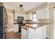 Bright kitchen features sleek, stainless steel appliances, ample cabinet space, and modern pendant lighting at 7355 Rush Ct, Orlando, FL 32818