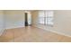 Bright living room featuring tile flooring, neutral walls, and a large window for natural light at 7355 Rush Ct, Orlando, FL 32818