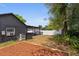 Fenced backyard featuring a wood patio cover with a patio set on a beautiful sunny day at 833 N Thornton Ave, Orlando, FL 32803