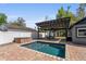 Outdoor backyard area featuring a pool, a shaded pergola, and a hot tub for relaxation at 833 N Thornton Ave, Orlando, FL 32803