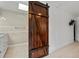 Bathroom features a decorative sliding barn door and a modern vanity at 833 N Thornton Ave, Orlando, FL 32803