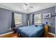 Bedroom with hardwood floors, two windows with natural light and closet at 833 N Thornton Ave, Orlando, FL 32803