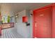 A bright red door with a mail slot welcomes you to this home's covered front porch at 833 N Thornton Ave, Orlando, FL 32803