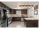 Updated kitchen features stainless appliances, dark wood cabinetry, and stone countertops at 833 N Thornton Ave, Orlando, FL 32803