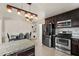 Eat-in kitchen with stainless steel appliances, dark cabinets, and stone countertops at 833 N Thornton Ave, Orlando, FL 32803