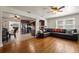 Open concept floor plan with hardwood floors, a view into the kitchen, and lots of natural light at 833 N Thornton Ave, Orlando, FL 32803