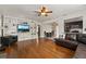 Bright living room with hardwood floors, a ceiling fan, and built in shelves, with a view to the kitchen at 833 N Thornton Ave, Orlando, FL 32803
