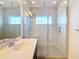 Bathroom features a marble shower with a bench and frameless glass door at 869 Taramundi Dr, Oviedo, FL 32765